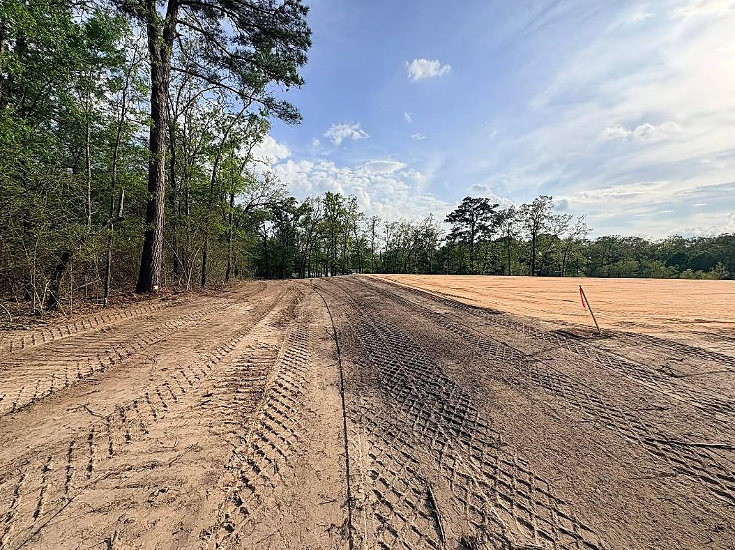Graded house pad and access built by Gardner Excavating in the East Texas pines